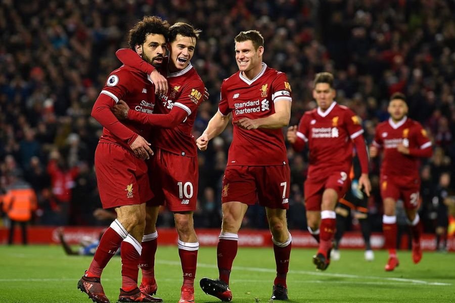 Players cheering after scoring goal during a Liverpool match